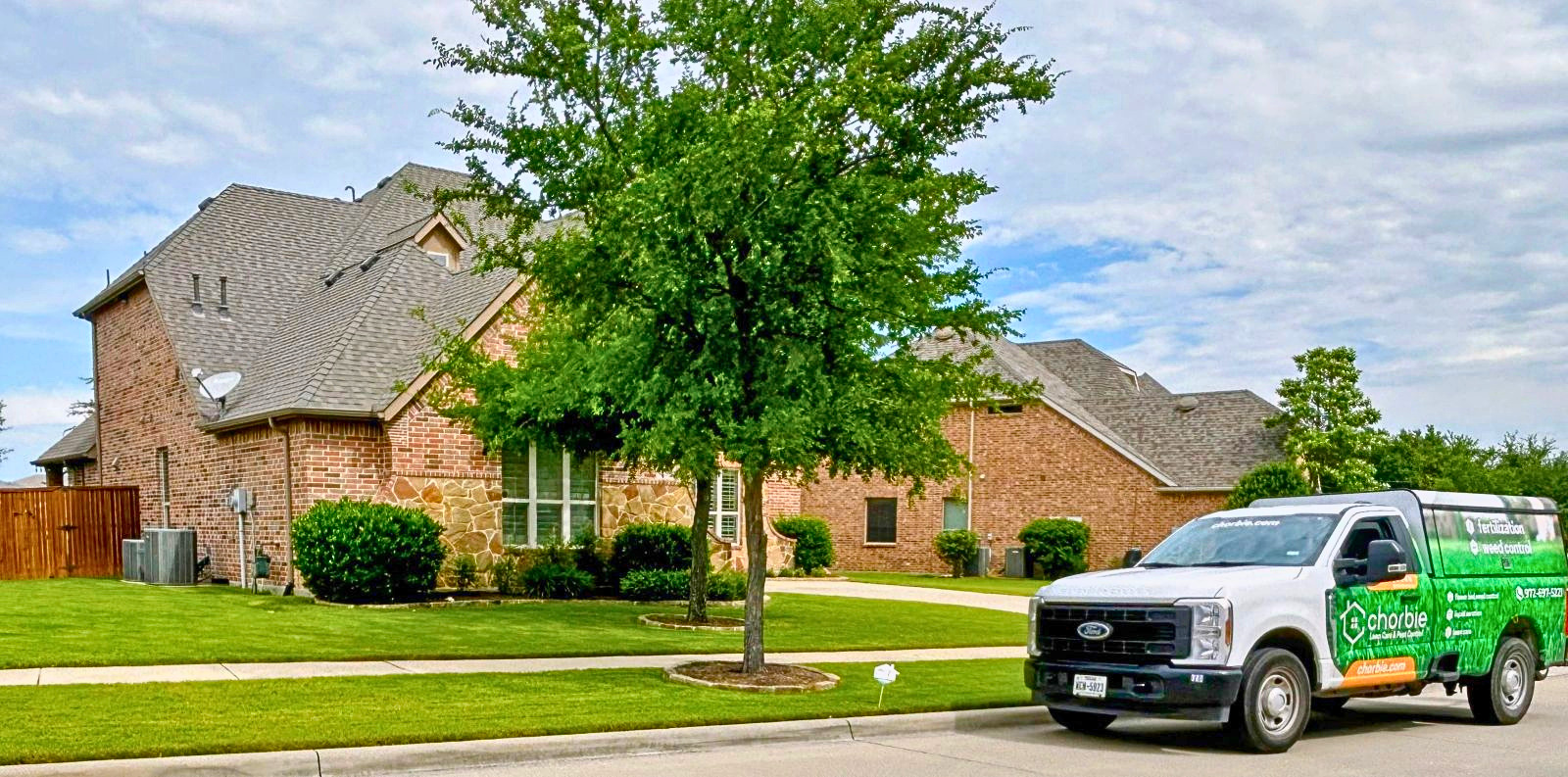 Chorbie lawn care technician treating crabgrass in a North Texas lawn